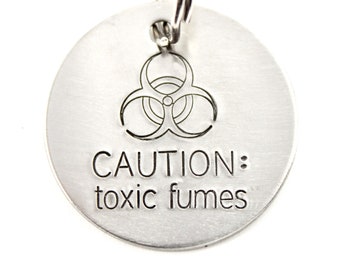 1.25 inch " CAUTION:  toxic fumes" pet ID tag, personalized with your pet's name and phone number on the back