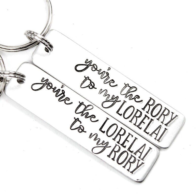 May include: Two silver keychains with the text "You're the Rory to my Lorelai" and "You're the Lorelai to my Rory" engraved on them.