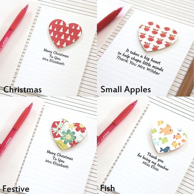 May include: Four handmade cards with different designs. Each card features a heart-shaped paper cutout with a different pattern. The cards have handwritten messages on them. The cards are on a lined notebook page.
