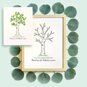 Puede incluir: Ilustración de árbol enmarcada con un marco de madera clara y una tarjeta más pequeña con un diseño de árbol similar. Las ilustraciones de árboles tienen un tronco y ramas negros, con hojas verdes y amarillas. El texto dice: "De pequeñas semillas crecen árboles poderosos. Gracias por ayudarnos a crecer."