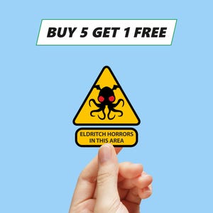 May include: Yellow warning sign with a black silhouette of a tentacled creature with red eyes. The sign reads "Eldritch Horrors in this area".
