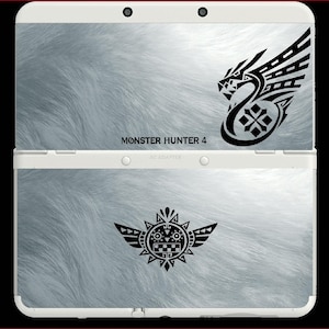 May include: A white Nintendo 3DS console with a light gray, furry texture design. The console features black graphic designs and the text "MONSTER HUNTER 4". The console is open, displaying the top and bottom screens.