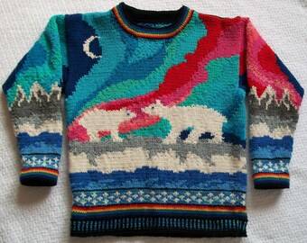May include: A long-sleeve knit sweater featuring a colorful arctic scene with two white polar bears standing on a gray ice shelf. The background displays a vibrant sky with shades of blue, pink, and green, a crescent moon, and mountains.