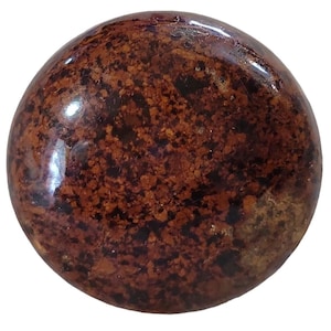 May include: A round, smooth, polished stone with a brown and black speckled pattern. The stone has a glossy finish.