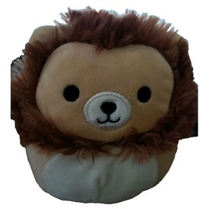 May include: A plush lion toy with a tan body and a brown mane. The lion has black eyes and a white muzzle. The toy is round and soft, designed for children.