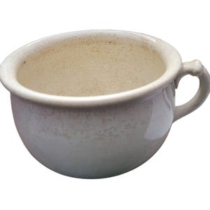May include: A white ceramic chamber pot with a handle. The pot has a crazed glaze and is slightly discolored.