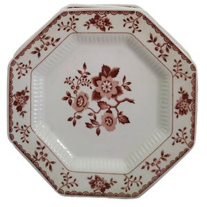 May include: Set of octagonal white plates with a floral design in shades of brown. The plates have a scalloped edge and a central floral motif, perfect for serving meals.