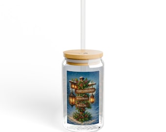 May include: A clear glass tumbler with a bamboo lid and a clear straw. The glass features a graphic of a wooden signpost decorated with pine branches, berries, and glowing lanterns, with the text Merry Christmas, Warm Wishes, and Xmas Joy.