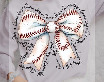 May include: A white sweatshirt with a baseball-themed bow design. The bow is made of white fabric with red stitching and is surrounded by the text "Game Day" repeated multiple times. The text is in black and white. The sweatshirt is ready to press.