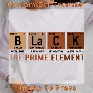 May include: A white sweatshirt with a brown, black, and white graphic design featuring the periodic table elements for boron, lanthanum, carbon, and potassium. The graphic reads "BLACK THE PRIME ELEMENT".
