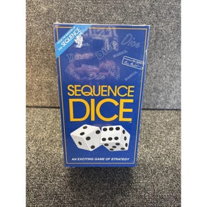 May include: A blue box of "Sequence Dice" game. The box features the game title in yellow and white dice illustrations. The text "An exciting game of strategy" is at the bottom. The box also includes the text "From the makers of the Sequence Game".