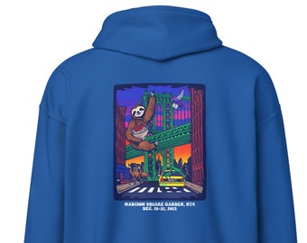 May include: A blue hoodie with a graphic print of a sloth hanging from a bridge in a city setting. The text "MADISON SQUARE GARDEN, NYC DEC. 29-31, 2023" is printed below the graphic.
