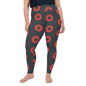 May include: Black leggings with a red donut pattern. The leggings are high-waisted and have a stretchy fit.