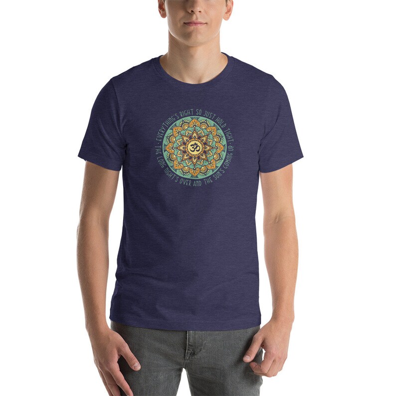 May include: A navy blue t-shirt with a mandala design and the text "Everything's right so just hold tight - the long night's over and the sun's coming up".