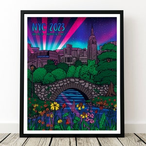 May include: A colorful illustration of the New York City skyline with the Empire State Building in the center. The skyline is set against a purple and pink sky with stars. A bridge over a river with flowers and greenery in the foreground. The text "NYC 2023" and "JULY 28-30 | AUGUST 1-2 & 5" is at the top of the image.