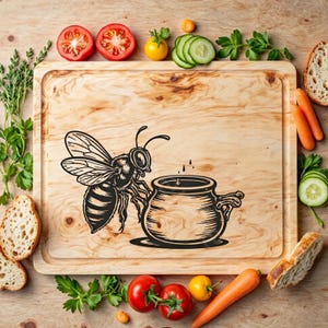 May include: A wooden cutting board with a black and white illustration of a bee dipping its head into a pot of honey. The board is surrounded by vegetables and fruit, including carrots, cucumbers, tomatoes, and lemons.
