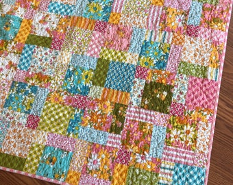 Baby Crib Quilt in pink, green, cream, blue, yellow, orange — A Blooming Bunch fabric — retro 1970