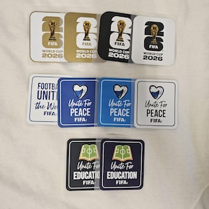 May include: A collection of square stickers featuring FIFA World Cup 2026 branding, Unite For Peace designs with heart graphics, and Unite For Education designs with book graphics. The stickers are displayed in rows with various color backgrounds.