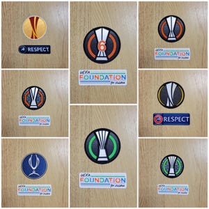 Peut inclure: Un collage de neuf patchs brodés représentant un trophée avec le texte "UEFA FOUNDATION for children" et "RESPECT".
