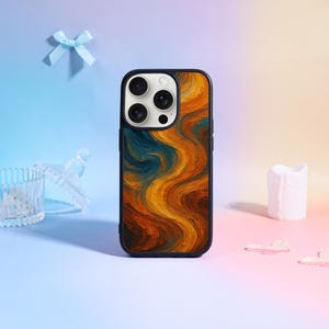 May include: A black phone case with a vibrant abstract design in shades of orange, yellow, and teal. The case features a glossy finish and a protective bumper. The phone case is designed for a smartphone.