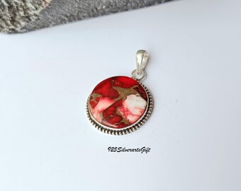 May include: A circular pendant with a silver loop and a red, white, and gold stone. The stone is set in a silver bezel with a beaded edge. The text "925SilverartsGift" is at the bottom.