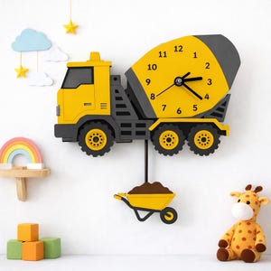May include: A yellow and grey cement mixer truck wall clock with black clock hands and numbers one to twelve on the mixer drum. A yellow wheelbarrow filled with brown material hangs from the truck as a pendulum on a black rod.