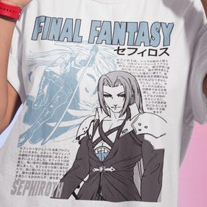 May include: White t-shirt featuring the text "FINAL FANTASY" and a graphic of a character named Sephiroth. The design includes Japanese text and illustrations. The model is wearing gold hoop earrings and a red watch.