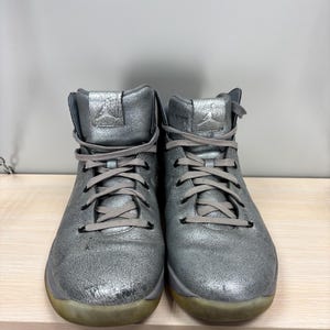 May include: A set of three ceramic mugs with a speckled, matte finish. The mugs are in shades of cream, light gray, and dark gray. Each mug has a simple, minimalist design and a rounded handle.