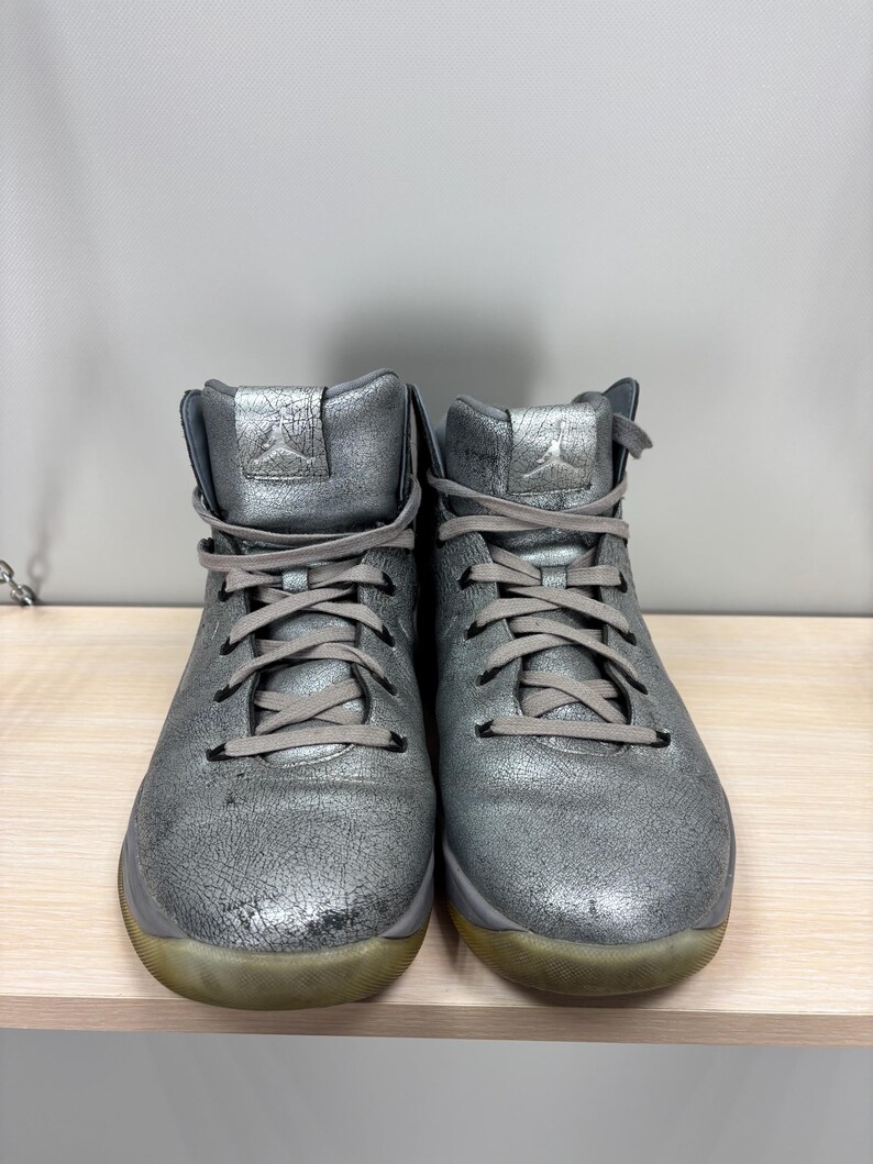 May include: A set of three ceramic mugs with a speckled, matte finish. The mugs are in shades of cream, light gray, and dark gray. Each mug has a simple, minimalist design and a rounded handle.