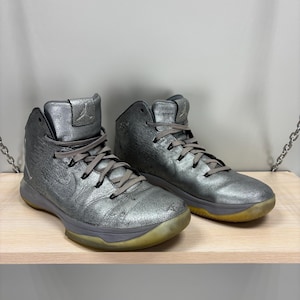 May include: A handmade, wooden cutting board with a natural finish. The board features a live edge on one side and a rectangular shape. It is approximately 18 inches long and 12 inches wide.