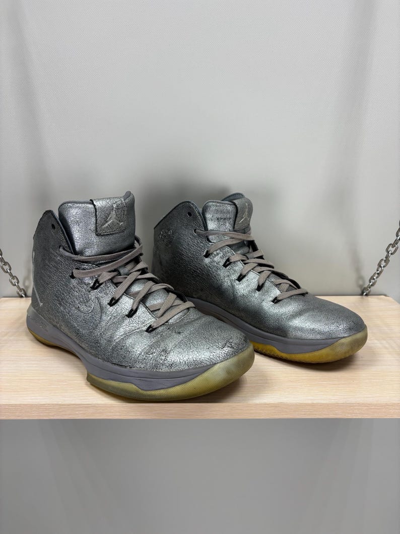 May include: A handmade, wooden cutting board with a natural finish. The board features a live edge on one side and a rectangular shape. It is approximately 18 inches long and 12 inches wide.