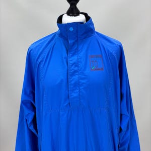 May include: A white ceramic mug with a black handle and the text "But First, Coffee" in a bold, black font. The mug is set against a neutral background, highlighting its simple design.