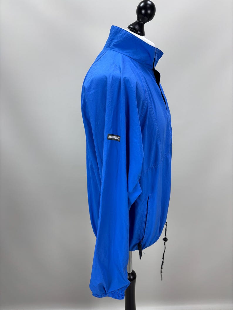 May include: A white ceramic mug with a black handle and the text "But First, Coffee" in a black, bold font. The mug is on a white surface.