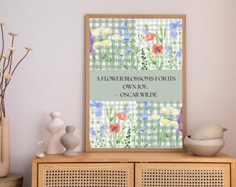 May include: A framed floral print featuring a watercolor design of wildflowers on a green and white checkered background. The print includes the quote "A flower blossoms for its own joy." by Oscar Wilde.