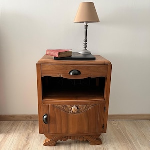 Black and wood art deco bedside table with mustache legs