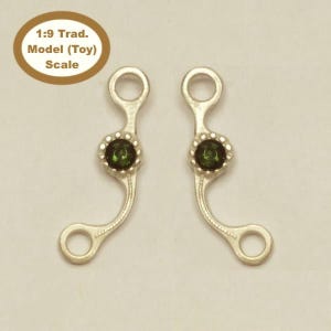 May include: A pair of silver horse bit pieces with green gemstone accents. 1:9 Trad. Model (Toy) Scale.