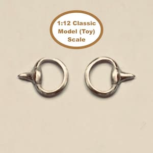 May include: Two silver-toned metal rings, each featuring a small, pointed protrusion on the outer edge. Above the rings, an oval graphic contains the text 1:12 Classic Model (Toy) Scale, indicating the size category for these miniature components.