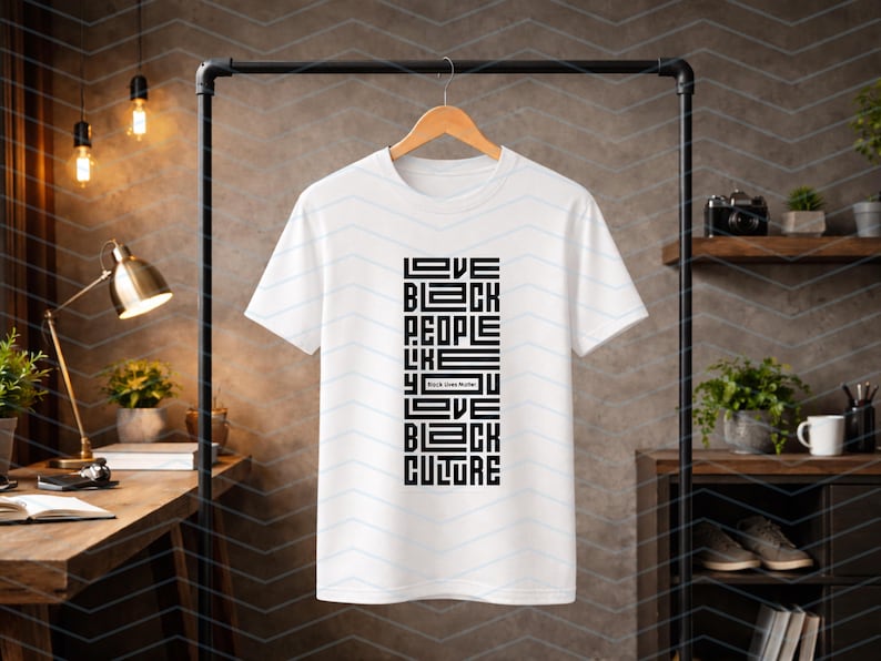 May include: White t-shirt with a black graphic design. The design features the words "LOVE BLACK PEOPLE LIKE YOU LOVE BLACK CULTURE" in a vertical, block-style font. The phrase "Black Lives Matter" is also included.