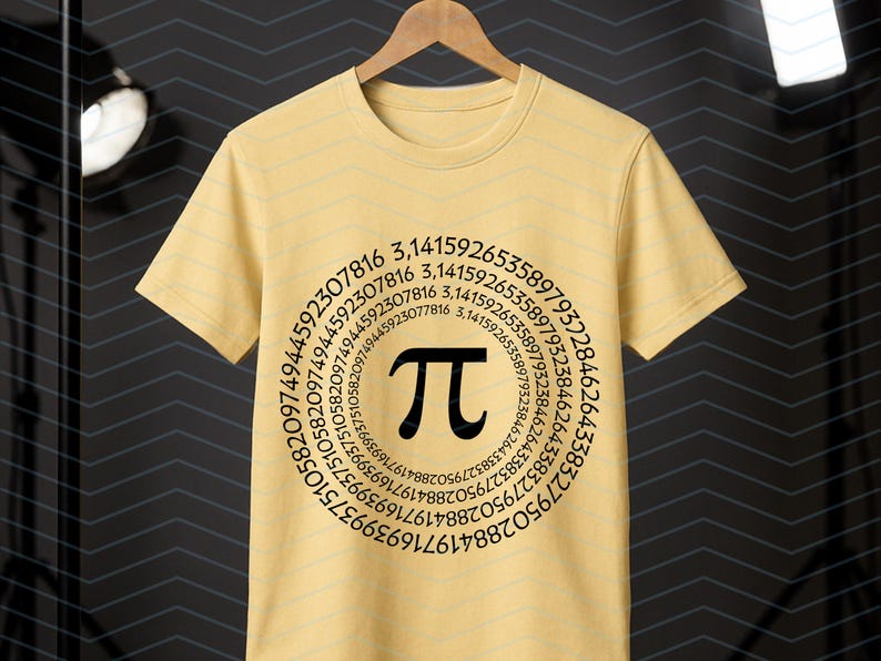 May include: A pale yellow t-shirt featuring a black Pi symbol encircled by a sequence of numbers. The tee is suspended on a wooden hanger, set against a dark backdrop.