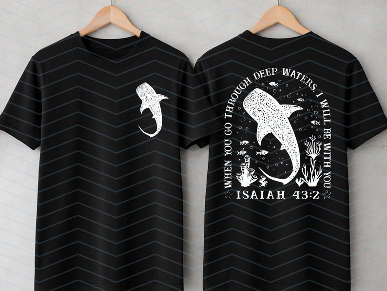 May include: Black t-shirt with a white whale shark graphic on the front and back. The back of the shirt features the text "When you go through deep waters, I will be with you. Isaiah 43:2."