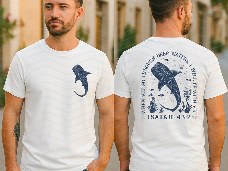 May include: White t-shirt with a navy blue whale shark graphic on the front and back. The back of the shirt features the text "WHEN YOU GO THROUGH DEEP WATERS, I WILL BE WITH YOU" and "ISAIAH 43:2" in navy blue.
