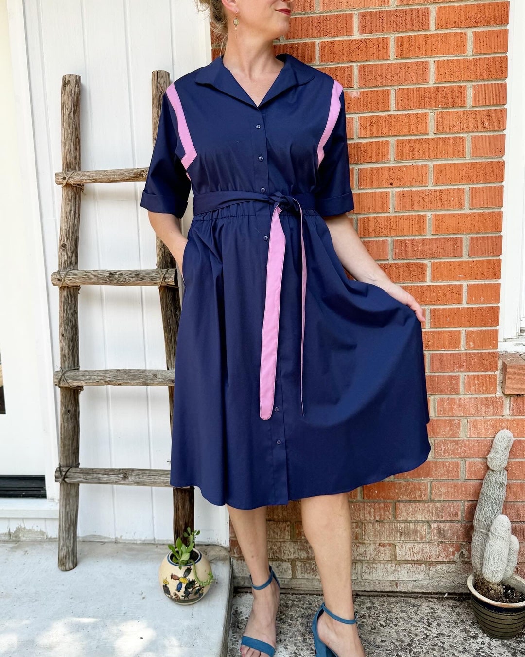 navy blue with pink dress Style a Pink Dress with Blue Accessories and Bold Platforms