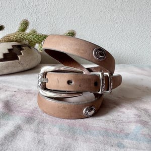 May include: A rustic wooden sign with the text "Welcome to our home" in a handwritten style. The sign has a distressed finish and a simple, inviting design, suitable for a front porch or entryway.