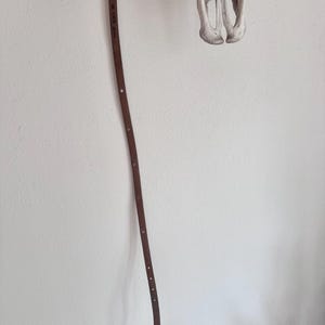 May include: A set of three ceramic mugs with a speckled, matte finish. The mugs are in shades of cream, light grey, and dark grey. Each mug has a simple, minimalist design, ideal for coffee or tea.