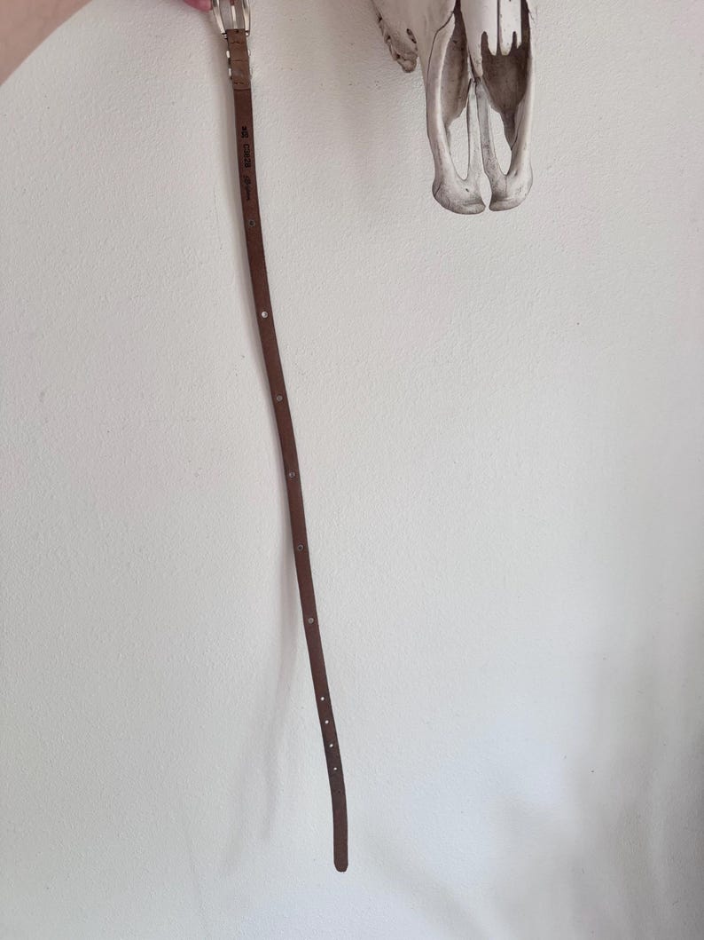 May include: A set of three ceramic mugs with a speckled, matte finish. The mugs are in shades of cream, light grey, and dark grey. Each mug has a simple, minimalist design, ideal for coffee or tea.