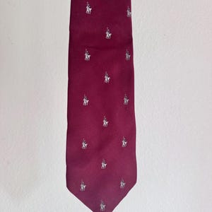 Vintage Resilio Maroon necktie  withrepeated silver horse and rider logo pattern.