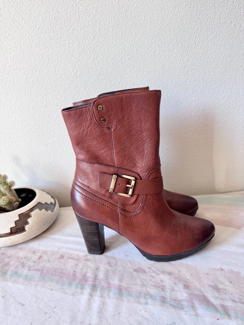 May include: A set of three ceramic mugs with a speckled, matte finish. The mugs are in shades of cream, light gray, and dark gray. Each mug has a simple, minimalist design, perfect for coffee or tea.