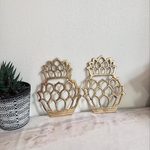 May include: Two gold-colored brass pineapple trivets. The trivets are made of solid brass and are designed to protect tables. The pineapple wall hangings are made in Taiwan and measure approximately 8 x 6 inches.