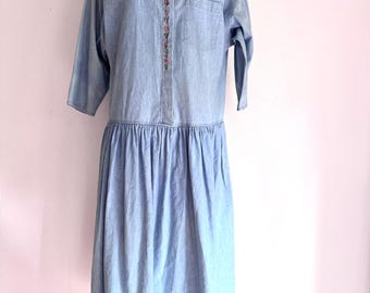 Vintage GAP light-wash denim drop-waist midi dress featuring embroidered details along the button placket and a relaxed fit.