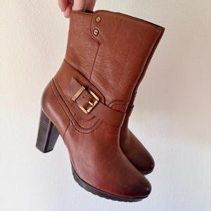 May include: A set of three ceramic mugs with a speckled, matte finish. The mugs are in shades of cream, light gray, and dark gray. Each mug has a simple, minimalist design, perfect for coffee or tea.